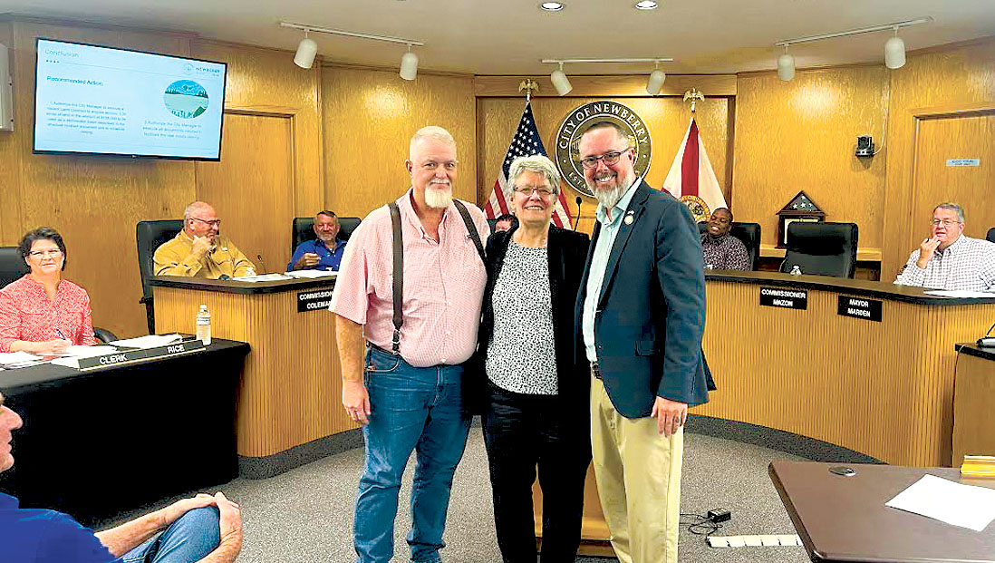 L-R: Newberry Assistant City Manager/Director of Utilities and Public Works, Jamie Jones, Mrs. Barlow, representing the Hooie Property and City Manager Jordan Marlowe commemorate the Commission’s approval to purchase land for the stormwater basin. / Photo special to Alachua County Today