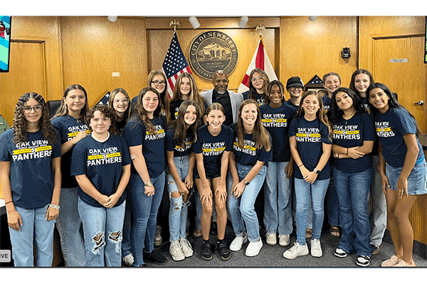 Members of the Oak View Middle School soccer team were honored by the Newberry City Commission for their 12-1-2 season. Coach Ashley Arnold is pictured with the team. Commissioner Tony Mazon stands at center rear.